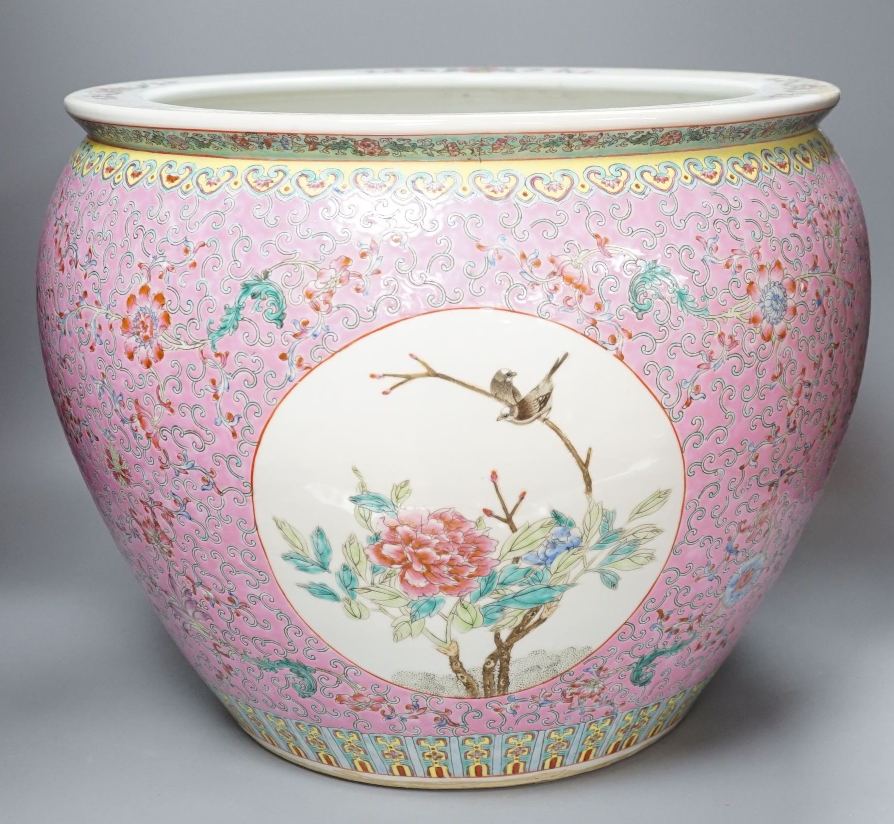 A Chinese famille rose fish bowl, 36 cms high.